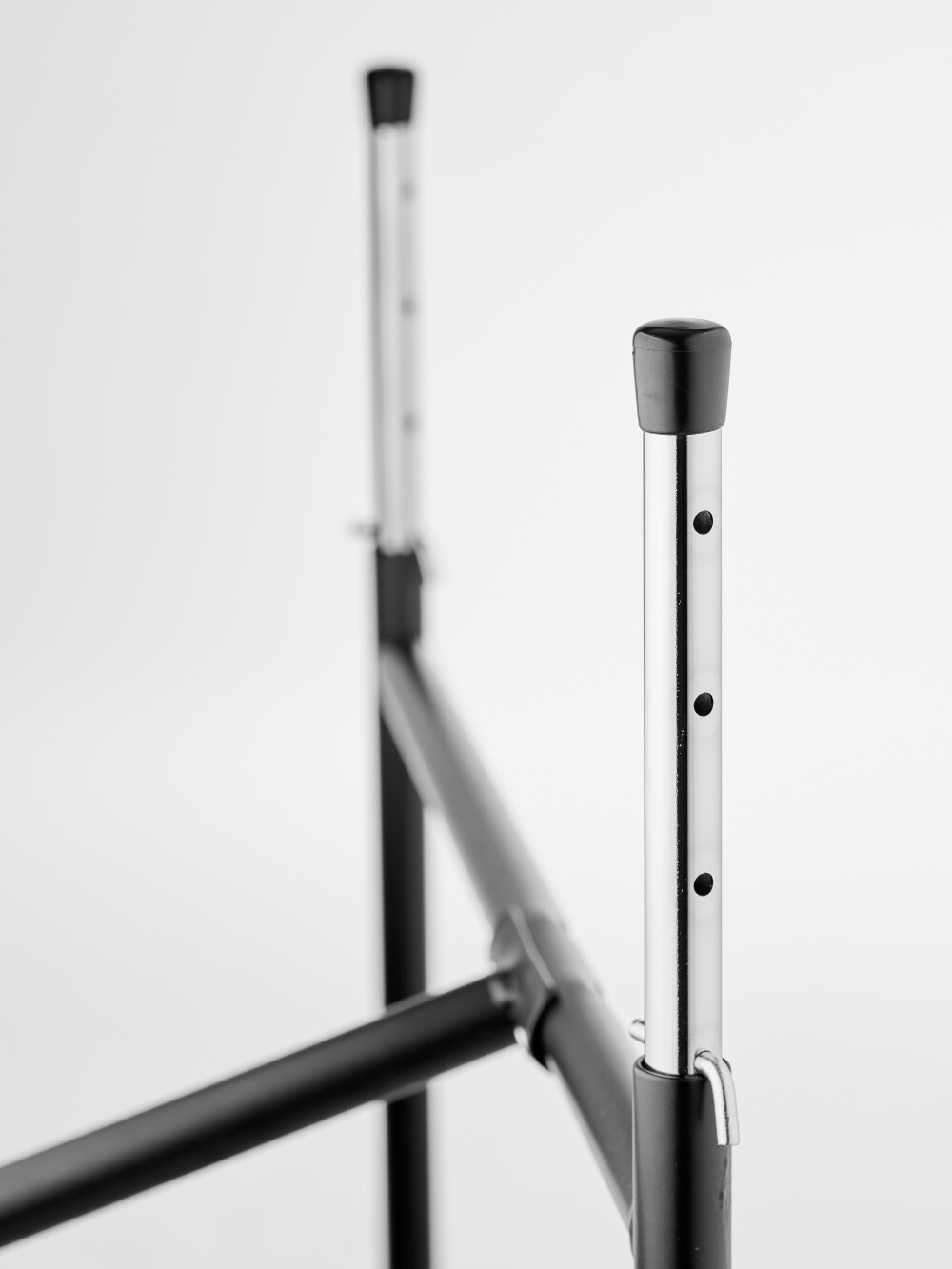 Detailed view of the long height adjusters (5 holes) for the E2 table frame with multiple grid levels.
