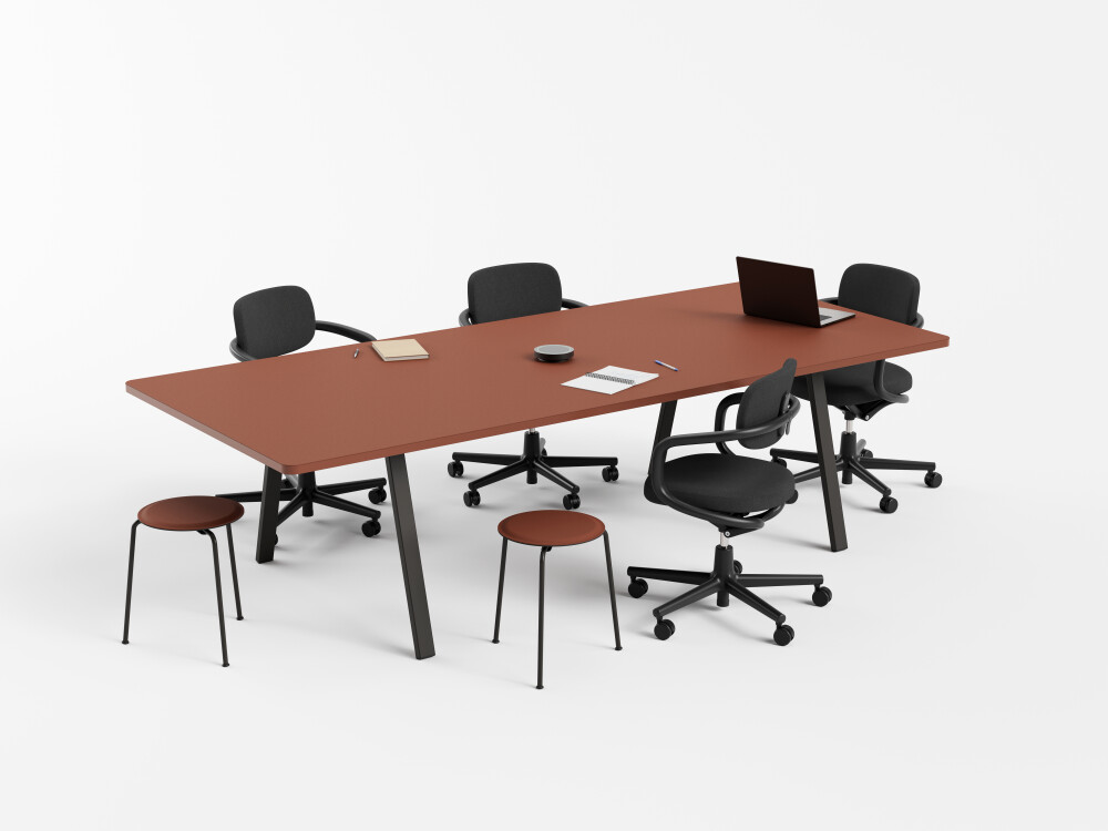 DIN Plus conference table with linoleum surface and rust-red edge, rectangular black metal legs and chairs in an office setting.