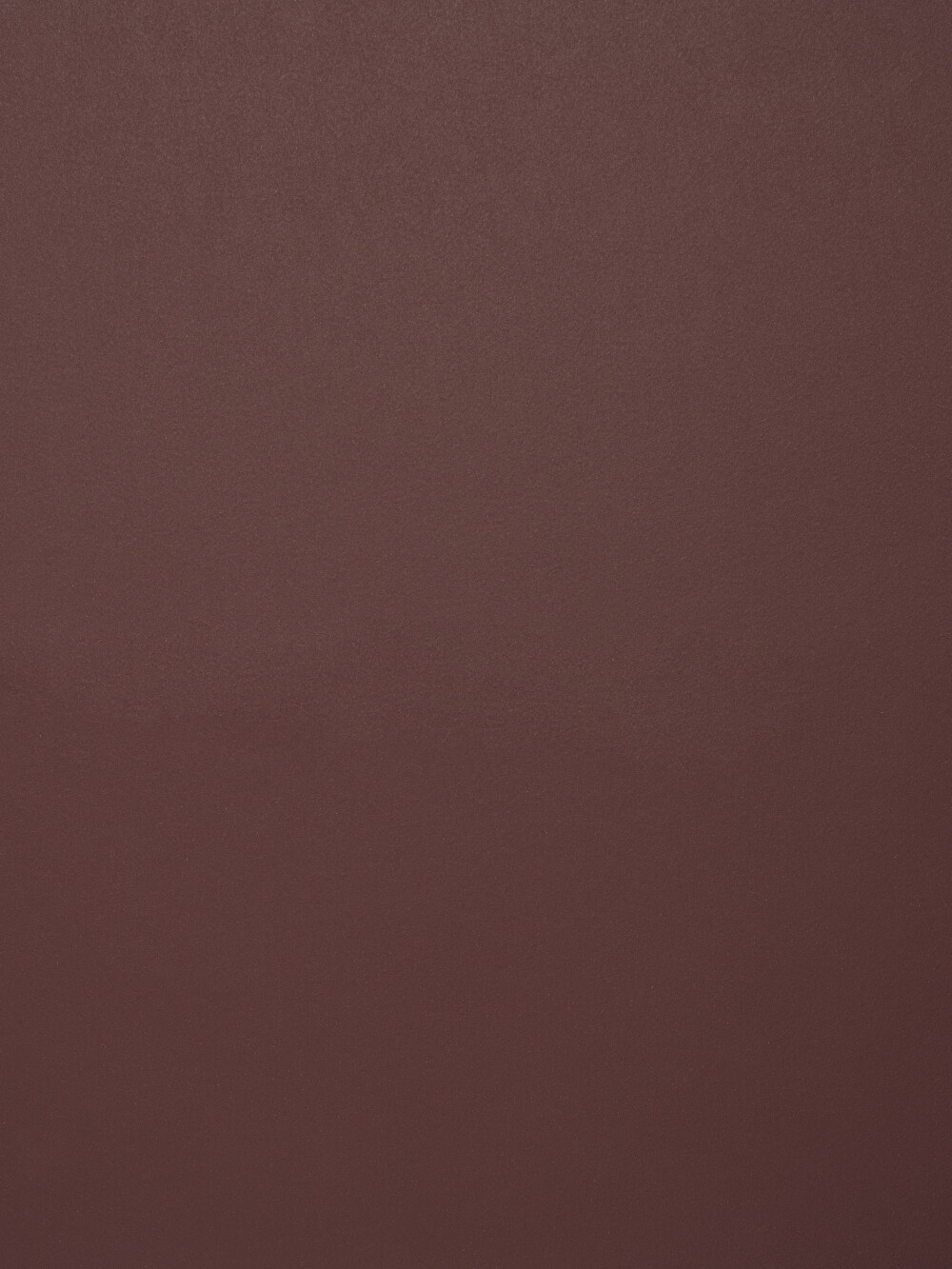 Nahaufnahme der Linoleum-Oberfläche in Burgundy von Faust – matt, fein strukturiert, in einem tiefen, burgundfarbenen Rotton gehalten.