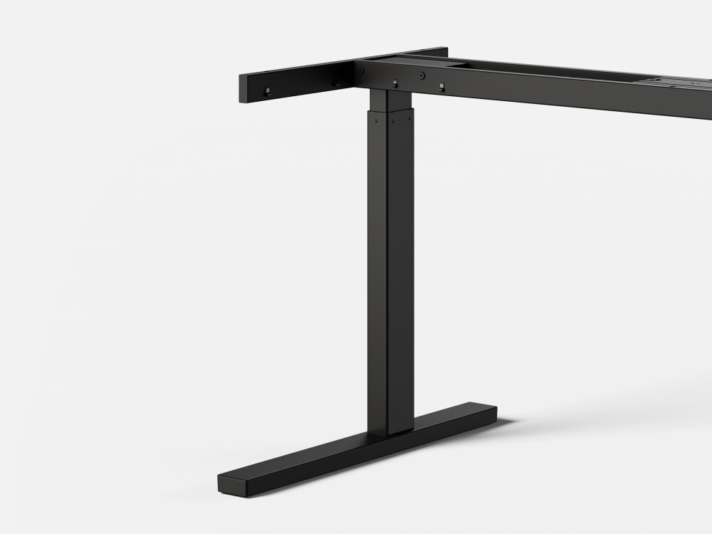 Detailed view of the ATS height-adjustable table system with black rectangular column and T-foot frame made of steel.