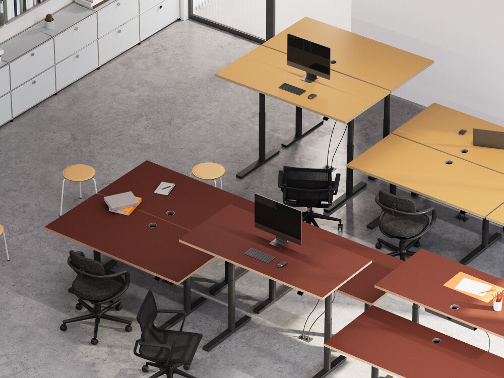 Modern office workstations with ATS height-adjustable desks in yellow and reddish brown, combined with black frames.