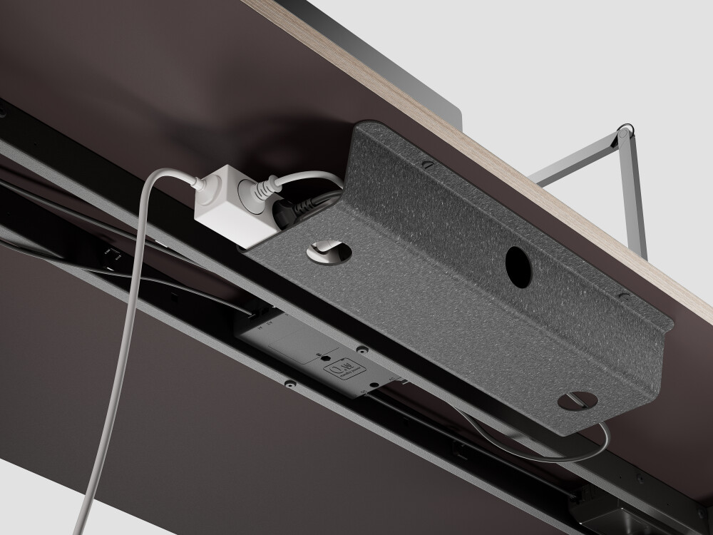 Lino cable tray under ATS desk, provides space for power strips, power supplies and cables, made of linoleum on the inside and Lefa on the outside.